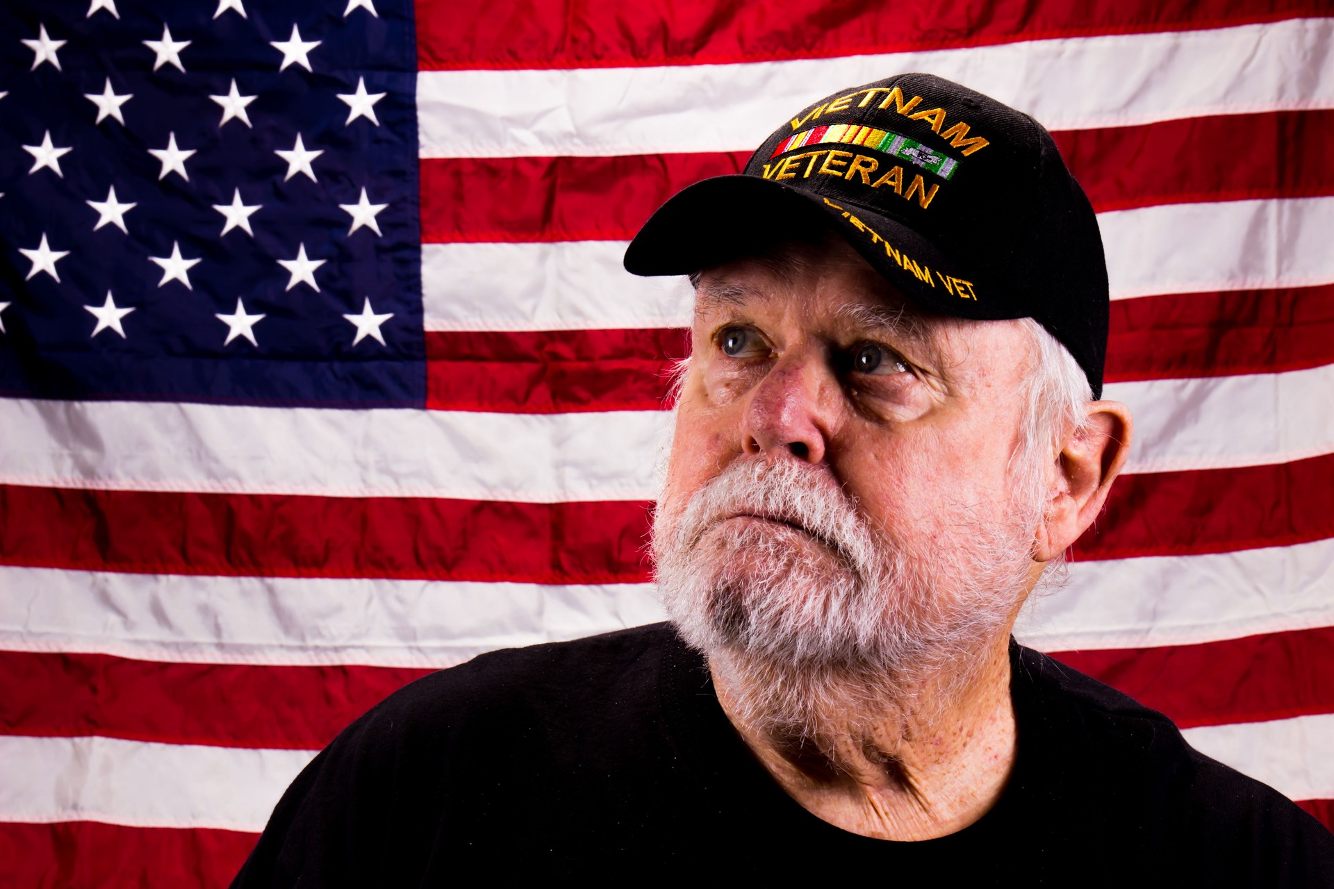 Vietnam Vet Looking Towards The Sky In Front Of American Flag